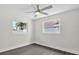 Well-lit bedroom with hardwood floors, modern fan, and inviting windows at 2175 Edythe Dr, Dunedin, FL 34698