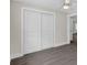 Bedroom featuring hardwood floors, closet, and neutral-toned walls at 2175 Edythe Dr, Dunedin, FL 34698