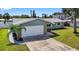 Single Gathering home with an attached garage and mature landscaping at 2175 Edythe Dr, Dunedin, FL 34698
