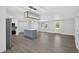 Open-concept kitchen features a center island, stainless steel appliances, and modern lighting fixtures at 2175 Edythe Dr, Dunedin, FL 34698