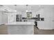 Bright, updated kitchen with stainless steel appliances, marble countertops, and white cabinets at 2175 Edythe Dr, Dunedin, FL 34698