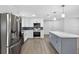 Open concept kitchen featuring a marble island, stainless steel appliances, and white cabinetry at 2175 Edythe Dr, Dunedin, FL 34698