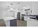 Bright, remodeled kitchen featuring stainless steel appliances, white cabinets, a navy backsplash, and a marble island at 2175 Edythe Dr, Dunedin, FL 34698