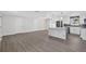 Spacious, remodeled kitchen with stainless steel appliances, white cabinets, and gray marbled island at 2175 Edythe Dr, Dunedin, FL 34698