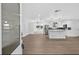 Bright, remodeled kitchen with new stainless appliances, white cabinets, and marble topped island at 2175 Edythe Dr, Dunedin, FL 34698