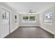 Living room with big windows offering natural light in an open floor plan at 2175 Edythe Dr, Dunedin, FL 34698