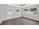 Bright and airy living room with backyard views with many windows and glass door at 2175 Edythe Dr, Dunedin, FL 34698