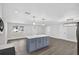 Bright, open concept living space with hardwood floors, white walls, recessed lighting, and kitchen island at 2175 Edythe Dr, Dunedin, FL 34698