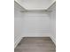 Empty walk-in closet with hardwood floors and hanging rod at 2175 Edythe Dr, Dunedin, FL 34698