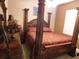 Luxurious bedroom showcases a four-poster bed, carpet, neutral walls, and elegant furnishings for a serene retreat at 25352 Doredo Dr, Punta Gorda, FL 33955