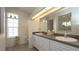 Bright bathroom featuring double vanity, tile floors, and natural light at 3102 Lema Dr, Spring Hill, FL 34609
