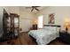 Inviting bedroom featuring hardwood floors, ceiling fan, and a cozy queen bed at 3102 Lema Dr, Spring Hill, FL 34609