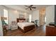 Spacious bedroom features hardwood floors, ceiling fan, exercise bike, and ensuite bathroom at 3102 Lema Dr, Spring Hill, FL 34609