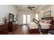 Bright bedroom features a queen size bed, ceiling fan, hardwood floors, and french doors at 3102 Lema Dr, Spring Hill, FL 34609