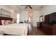 Well-lit bedroom with a large bed, hardwood flooring, and an ensuite bathroom at 3102 Lema Dr, Spring Hill, FL 34609