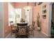 Cozy dining area with round table set by bright windows, complemented by charming decor at 3102 Lema Dr, Spring Hill, FL 34609