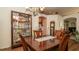 Classic dining room with a large table, ornate chandelier, and decorative glass cabinet at 3102 Lema Dr, Spring Hill, FL 34609