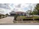 Charming single-story home with a well-manicured front yard, long driveway, and attached two-car garage at 3102 Lema Dr, Spring Hill, FL 34609