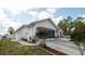 Single-story home with attached two-car garage and a long driveway at 3102 Lema Dr, Spring Hill, FL 34609