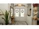 Bright foyer featuring double doors with stained glass, neutral colors, and tasteful decor at 3102 Lema Dr, Spring Hill, FL 34609