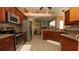 Well-equipped kitchen with stainless steel appliances, granite countertops, and tile flooring at 3102 Lema Dr, Spring Hill, FL 34609
