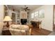 Comfortable living room featuring hardwood floors, a ceiling fan, and an entertainment center at 3102 Lema Dr, Spring Hill, FL 34609