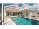 Sparkling in-ground pool with a screened enclosure and ample space for outdoor gatherings at 3102 Lema Dr, Spring Hill, FL 34609
