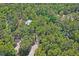 Aerial view of a secluded home surrounded by lush green trees, highlighting privacy and natural beauty at 3431 Riderwood Dr, Dade City, FL 33523