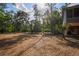 Expansive backyard with mature trees, lush foliage, and partial view of home's exterior at 3431 Riderwood Dr, Dade City, FL 33523