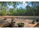 Spacious backyard deck surrounded by lush trees and greenery on a sunny day at 3431 Riderwood Dr, Dade City, FL 33523