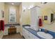 Bathroom featuring a vanity with double sinks, drawers, and a window at 3431 Riderwood Dr, Dade City, FL 33523