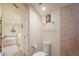 Bright bathroom with a walk-in tiled shower, white toilet, and a doorway leading to a soaking tub at 3431 Riderwood Dr, Dade City, FL 33523