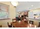 Bright dining area with wood table and view into living room with fireplace at 3431 Riderwood Dr, Dade City, FL 33523