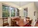 Dining room with a wooden table and large windows overlooking the trees at 3431 Riderwood Dr, Dade City, FL 33523
