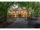 Charming two-story home featuring a wraparound porch, classic design, and lush, mature landscaping at 3431 Riderwood Dr, Dade City, FL 33523