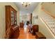 Warm and inviting foyer with hardwood floors, stairway, and an open view to the living area at 3431 Riderwood Dr, Dade City, FL 33523