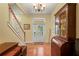 Elegant foyer with hardwood floors, staircase, and natural light streaming in from the front door at 3431 Riderwood Dr, Dade City, FL 33523