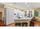 Bright kitchen boasts white cabinets, modern appliances, quartz counters, and a breakfast bar, ideal for cooking and gathering at 3431 Riderwood Dr, Dade City, FL 33523