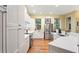 Bright kitchen features stainless steel appliances, white cabinetry, and an adjacent dining area with plenty of natural light at 3431 Riderwood Dr, Dade City, FL 33523