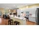 Open-concept kitchen offers quartz countertops, stainless appliances, and seamless transition to the living room at 3431 Riderwood Dr, Dade City, FL 33523
