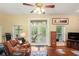 View of the living room with hardwood floors and french doors leading to a deck at 3431 Riderwood Dr, Dade City, FL 33523
