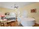 Comfortable bedroom features a white piano, light walls, and hardwood floors at 3431 Riderwood Dr, Dade City, FL 33523