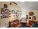 Comfortable office with a wooden desk, cushioned chair, and walls adorned with an array of framed memorabilia at 3431 Riderwood Dr, Dade City, FL 33523