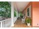 Expansive porch with rocking chairs and wood flooring, perfect for relaxing outdoors at 3431 Riderwood Dr, Dade City, FL 33523