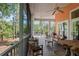 Inviting screened porch with comfortable seating and wooded views for relaxing and entertaining at 3431 Riderwood Dr, Dade City, FL 33523