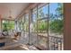 Screened-in porch with furniture and view of green trees at 3431 Riderwood Dr, Dade City, FL 33523