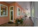 Exterior porch with seating, plants, and white door at 3431 Riderwood Dr, Dade City, FL 33523
