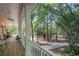 Spacious porch overlooking mature trees along walkway at 3431 Riderwood Dr, Dade City, FL 33523