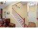 Elegant staircase featuring wood treads, white risers, and a classic wood railing, adding charm to the home's interior at 3431 Riderwood Dr, Dade City, FL 33523