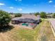 Aerial view of home showing screened pool, lanai, and well-manicured lawn at 3464 Misty View Dr, Spring Hill, FL 34609